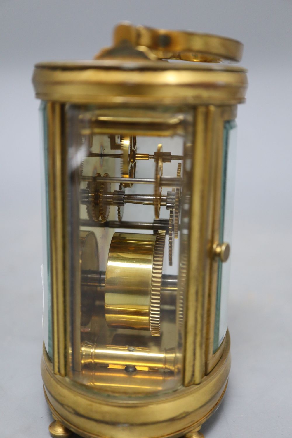 An oval brass carriage clock, height 12cm (handle down)